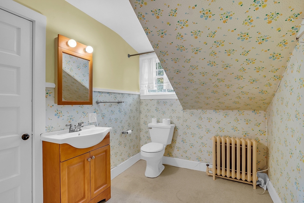 42 Locust Street Marblehead, MA 01945 - Photo 35 of 42 a bathroom with a sink a toilet and a mirror