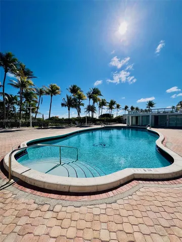a view of a swimming pool with a yard