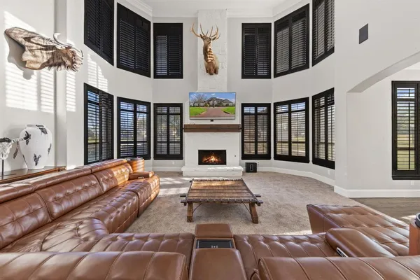 a living room with furniture fireplace and flat screen tv