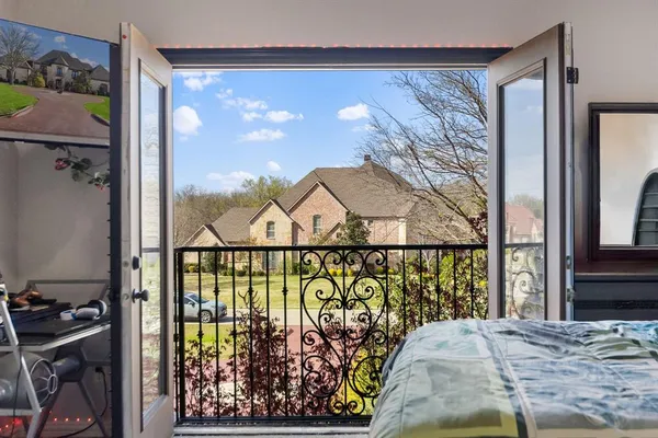 a bedroom with a bed and a chandelier