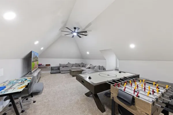 a living room with furniture kitchen view and a flat screen tv