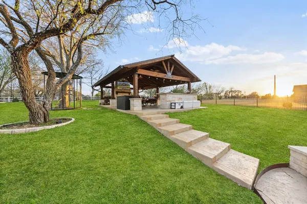 a view of a patio with a table chairs and a backyard