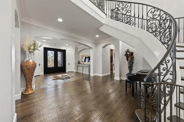a view of entryway and hall with wooden floor