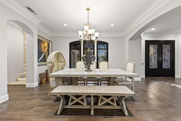 a view of a dining room with furniture wooden floor and chandelier