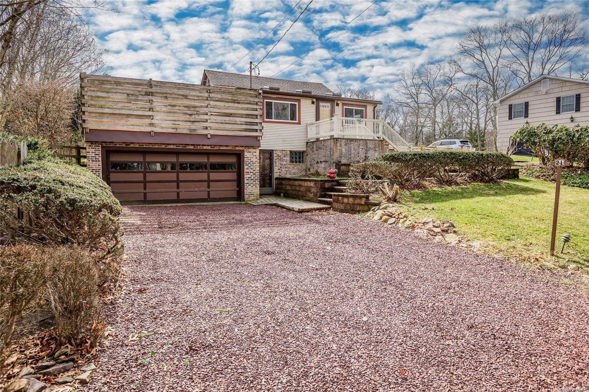 a view of a house with a yard and garage