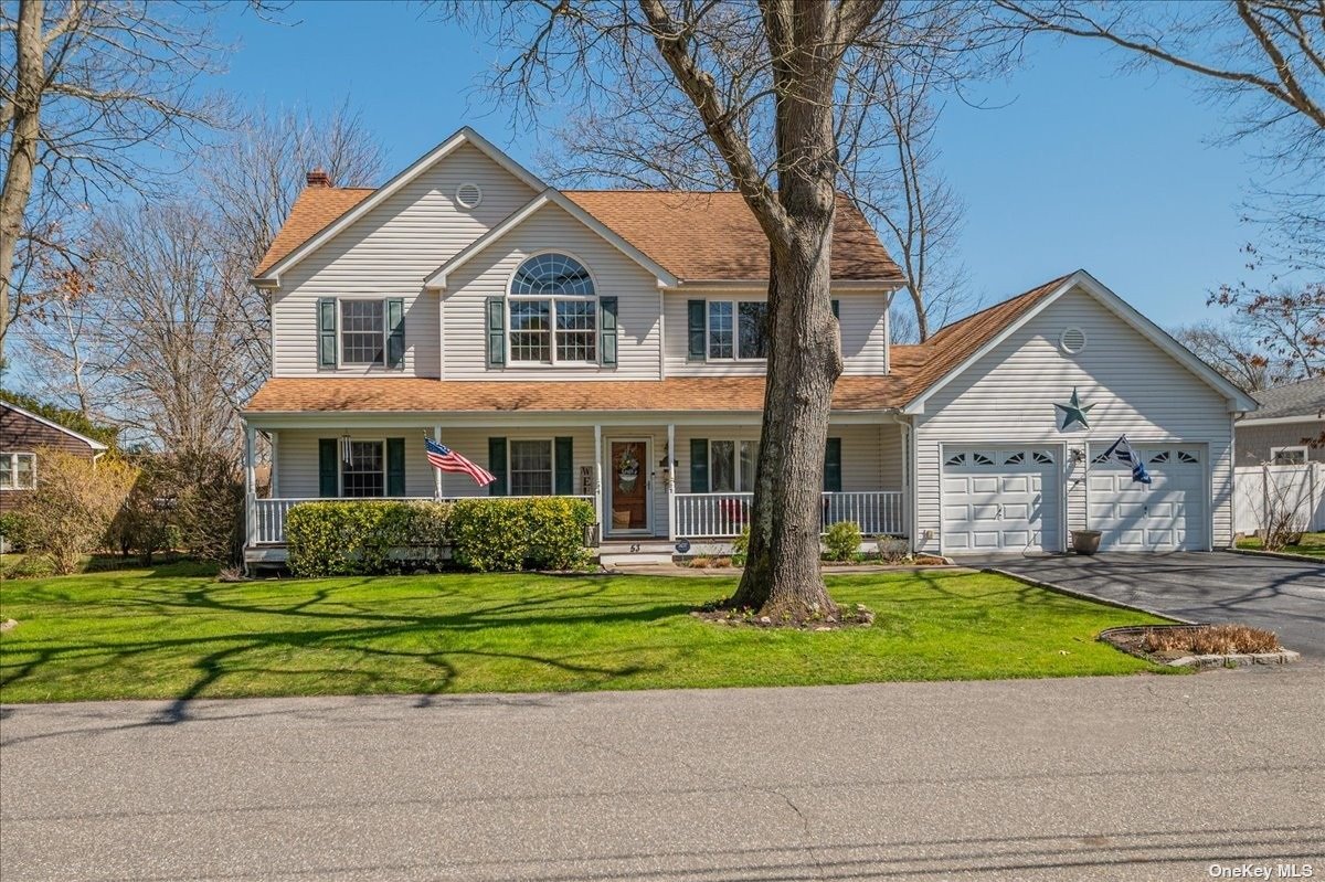 a front view of a house with a yard and potted plants