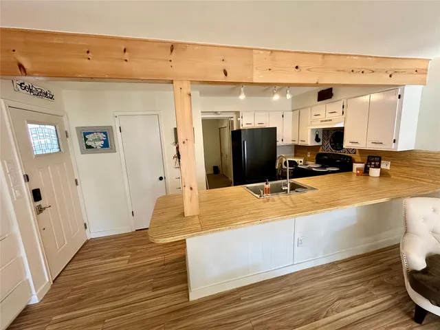 a spacious bathroom with stainless steel appliances a sink and a fireplace