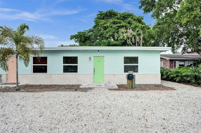 a house that has a tree in front of it