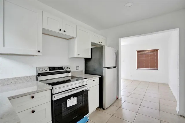 a kitchen with cabinets and steel stainless steel appliances