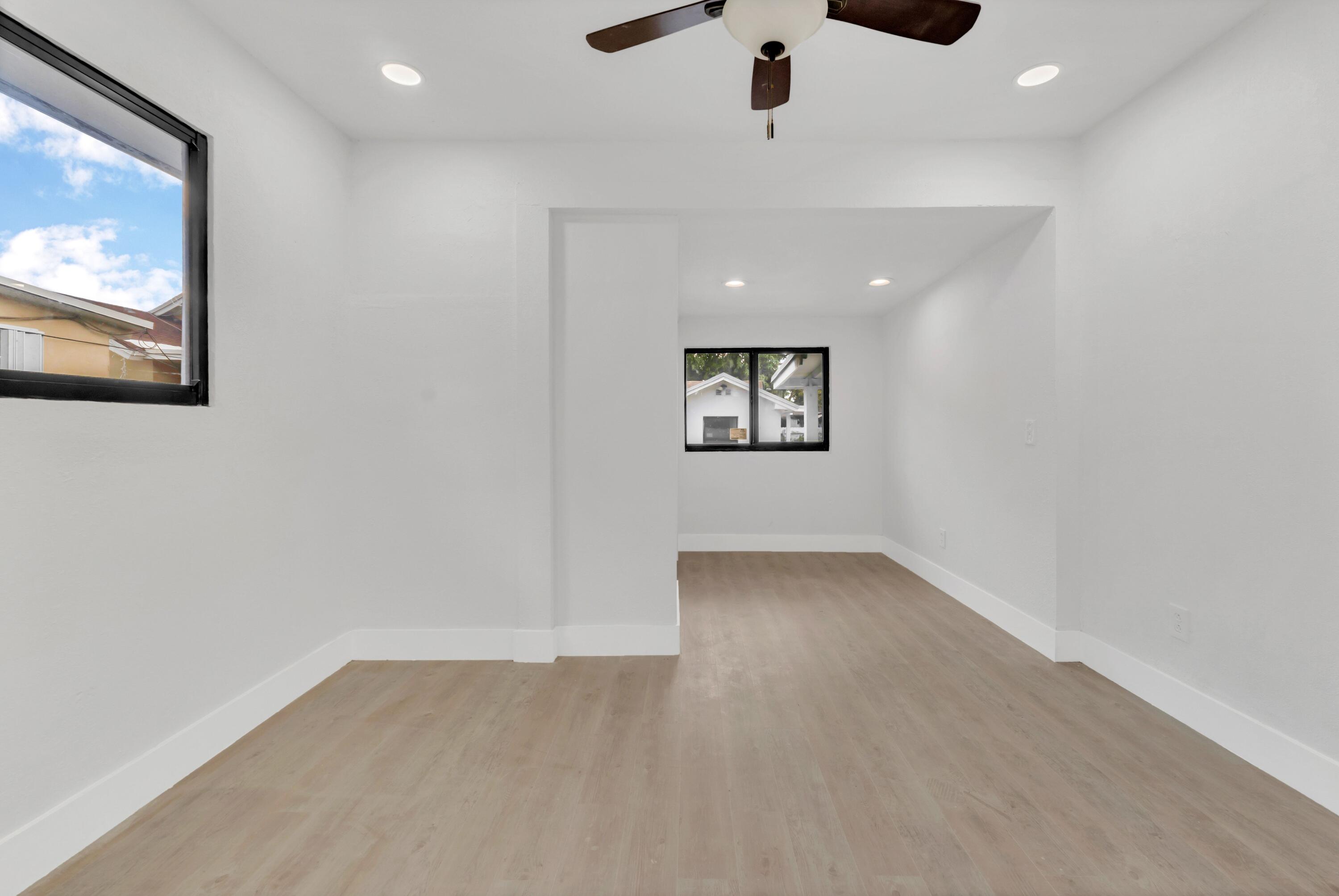 2428 Northwest 28th Street Miami, FL 33142 - Photo 12 of 19 wooden floor in an empty room with a window