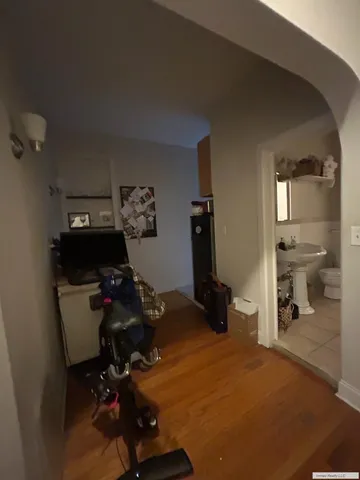 a view of a workspace with furniture and wooden floor