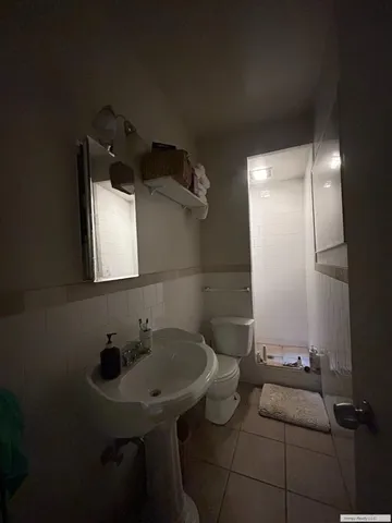 a kitchen with a refrigerator a sink and cabinets