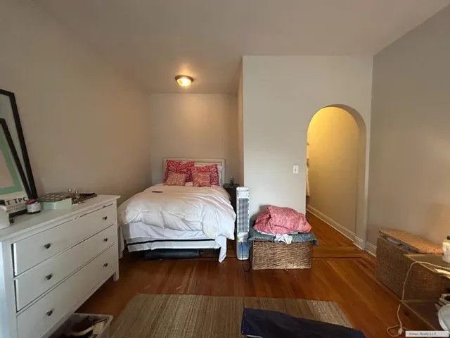 a bedroom with a bed and a dresser