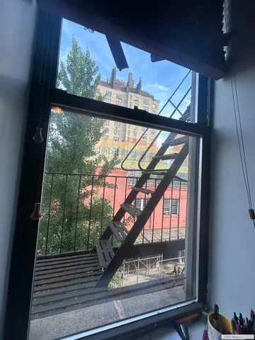 a view of a wooden door with a tree