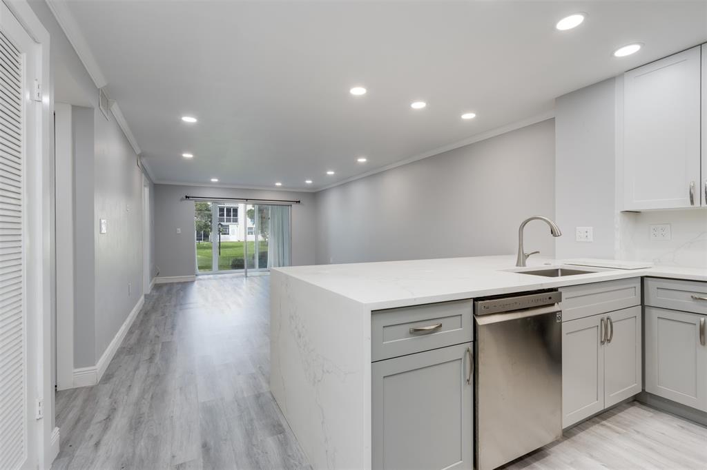 a view of a kitchen with sink and dishwasher