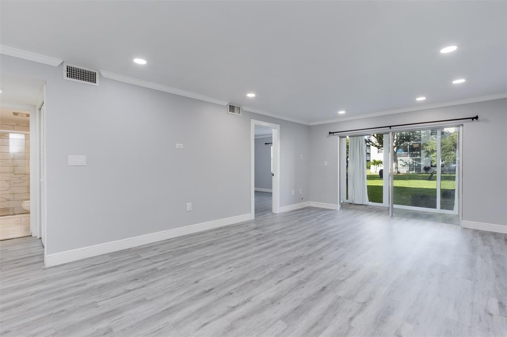 9856 Marina Boulevard, Unit 1314 Boca Raton, FL 33428 - Photo 17 of 43 a view of an empty room with wooden floor and a window