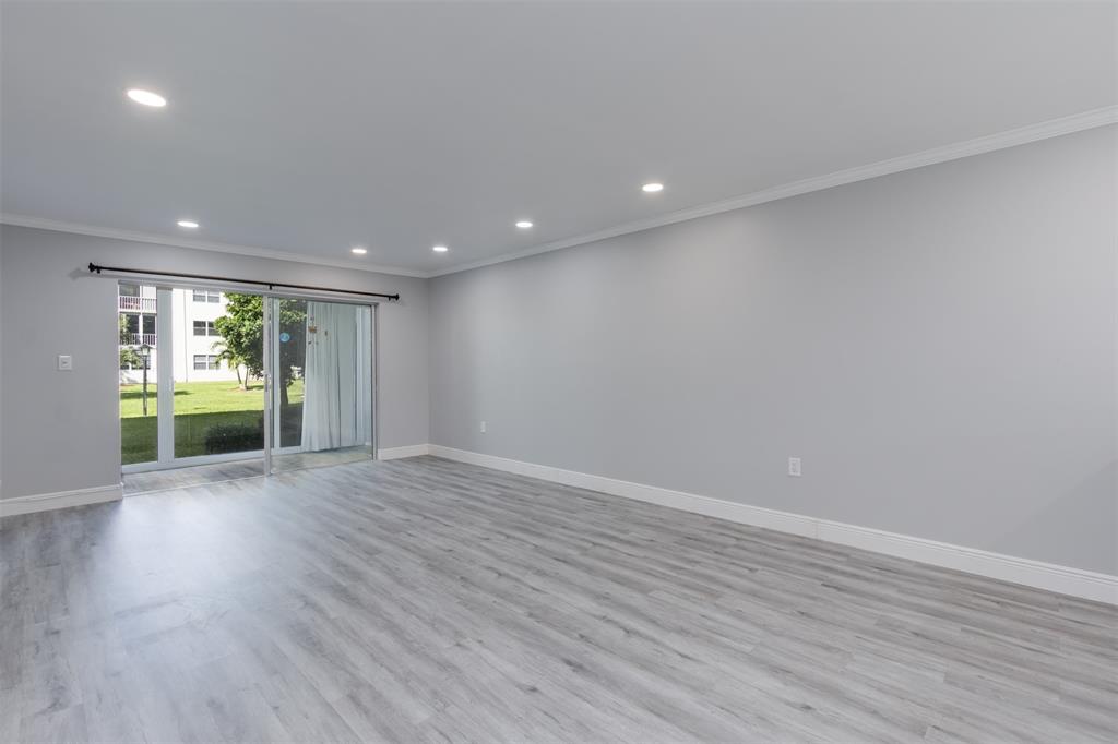 9856 Marina Boulevard, Unit 1314 Boca Raton, FL 33428 - Photo 18 of 43 a view of an empty room with wooden floor and a window