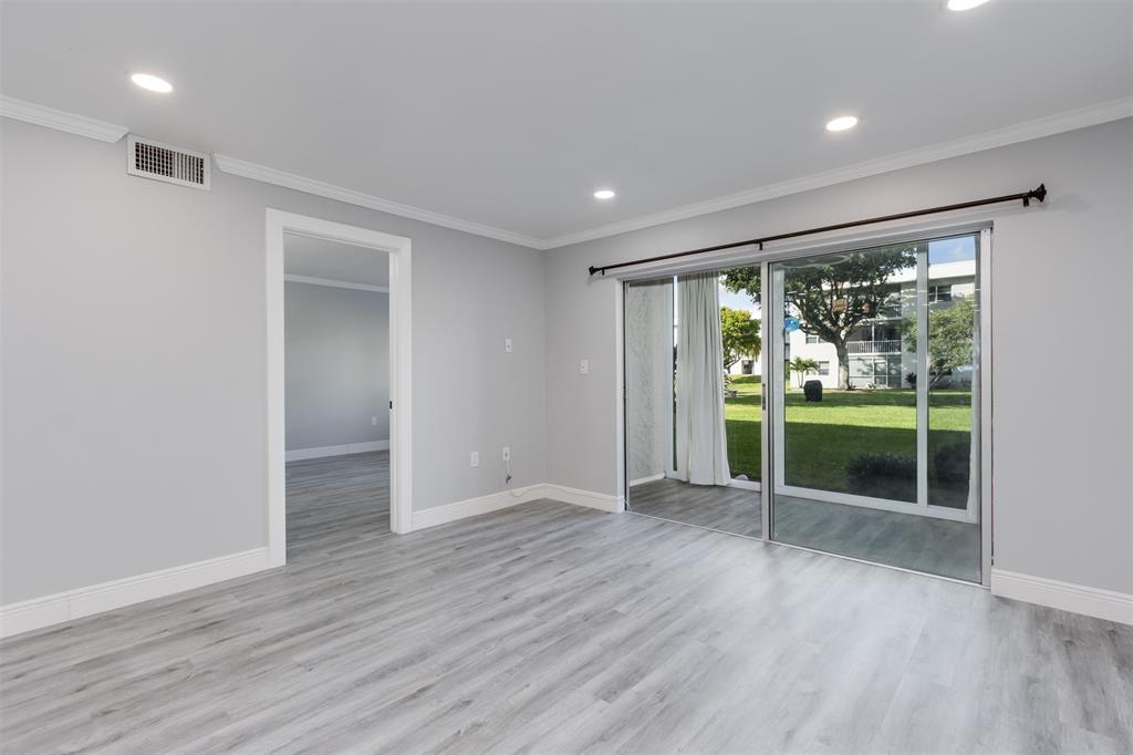 9856 Marina Boulevard, Unit 1314 Boca Raton, FL 33428 - Photo 19 of 43 a view of room with wooden floor and floor to ceiling window