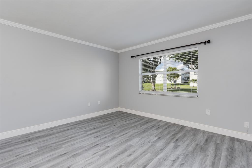 9856 Marina Boulevard, Unit 1314 Boca Raton, FL 33428 - Photo 21 of 43 wooden floor in an empty room with a window