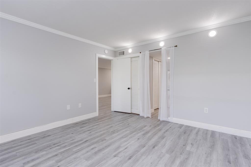9856 Marina Boulevard, Unit 1314 Boca Raton, FL 33428 - Photo 23 of 43 a view of an empty room with wooden floor