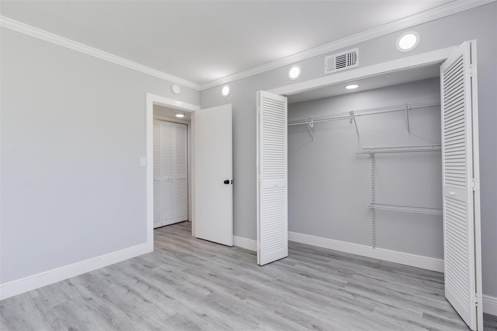 9856 Marina Boulevard, Unit 1314 Boca Raton, FL 33428 - Photo 29 of 43 a view of an empty room with wooden floor