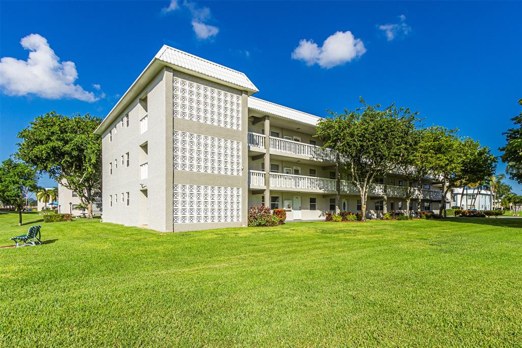 9856 Marina Boulevard, Unit 1314 Boca Raton, FL 33428 - Photo 3 of 43 a view of a house with a yard