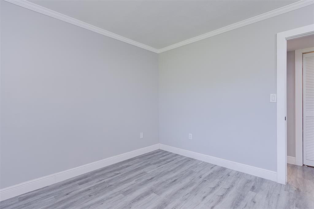 9856 Marina Boulevard, Unit 1314 Boca Raton, FL 33428 - Photo 31 of 43 a view of an empty room with wooden floor