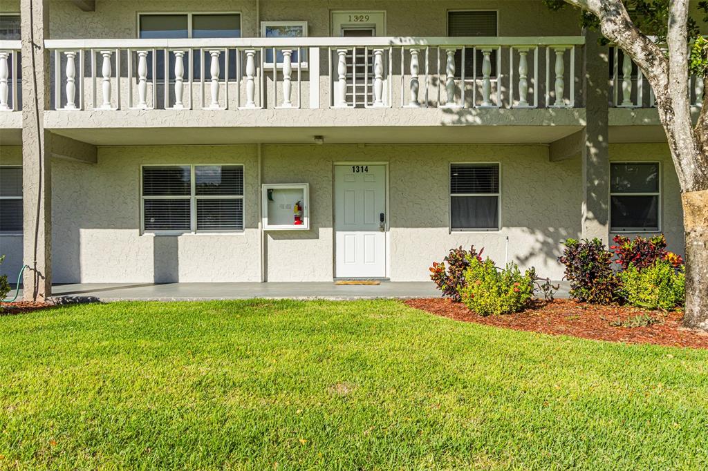 9856 Marina Boulevard, Unit 1314 Boca Raton, FL 33428 - Photo 5 of 43 a front view of a house with a yard