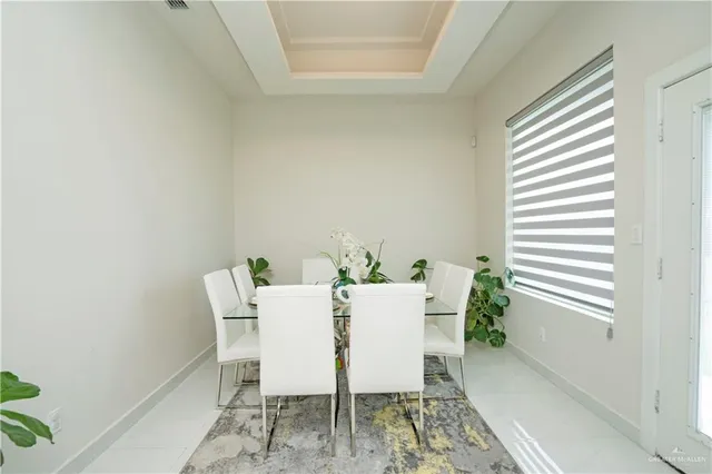 a view of a dining room with furniture and a window