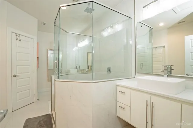 a bathroom with a shower sink and mirror
