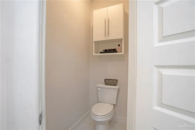 a white toilet sitting next to a white sink