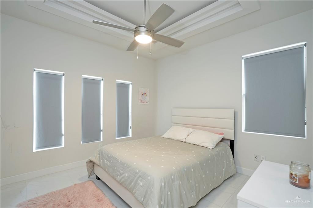 2008 South Erica Street Pharr, TX 78577 - Photo 17 of 25 a bedroom with a bed and a chandelier