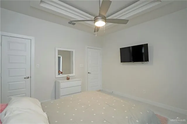 a bedroom with a bed and a flat screen tv