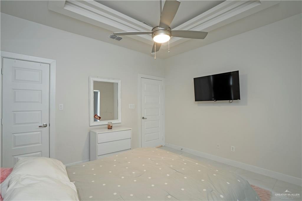 2008 South Erica Street Pharr, TX 78577 - Photo 18 of 25 a bedroom with a bed and a flat screen tv