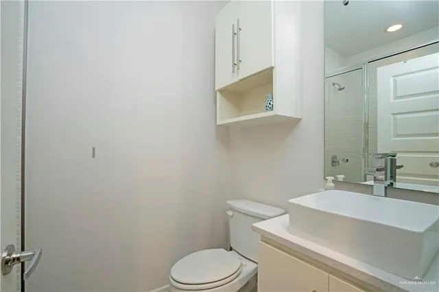 a white toilet sitting next to a bathroom sink