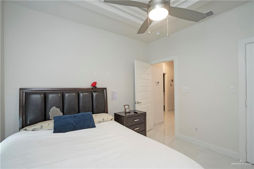 2008 South Erica Street Pharr, TX 78577 - Photo 21 of 25 a bedroom with a bed and a chandelier
