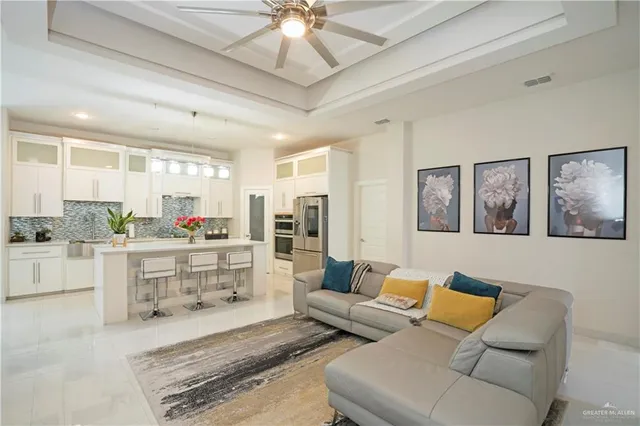 a living room with furniture and view of kitchen