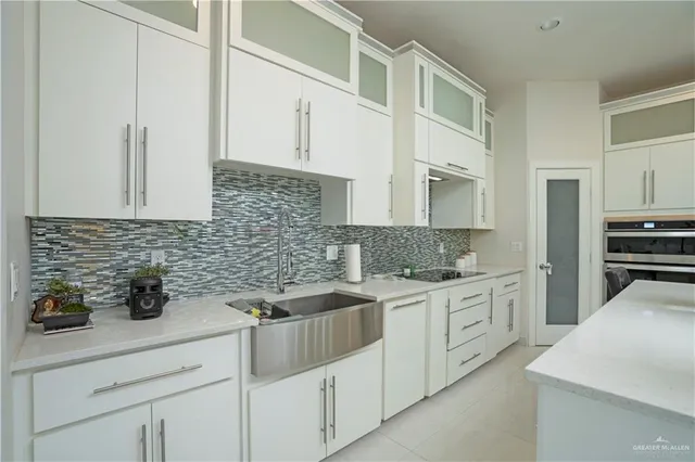 a kitchen with white cabinets and white appliances