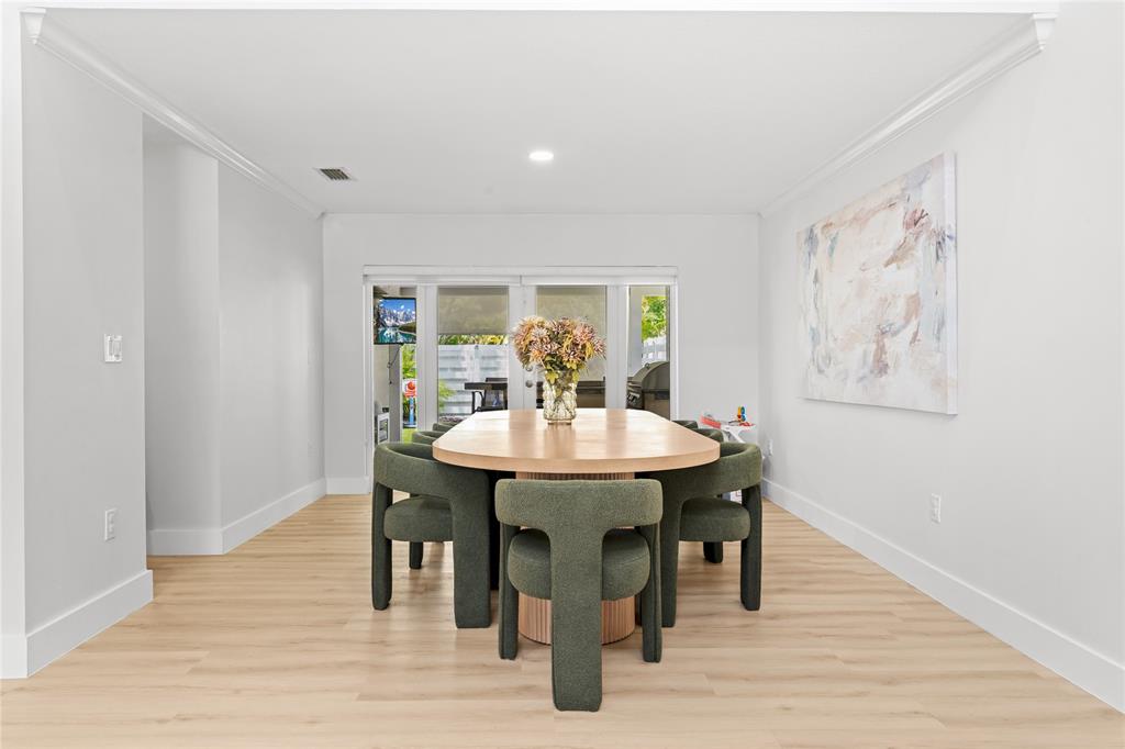 14908 Southwest 143rd Place Miami, FL 33186 - Photo 14 of 45 a view of a dining room with furniture and wooden floor