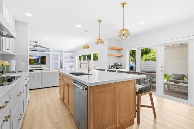 a kitchen with a stove a sink a dining table and chairs