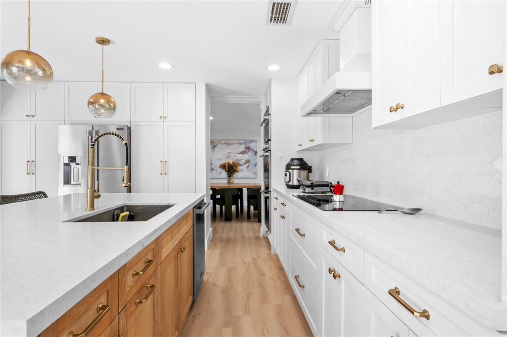14908 Southwest 143rd Place Miami, FL 33186 - Photo 17 of 45 a kitchen with kitchen island a sink and a stove