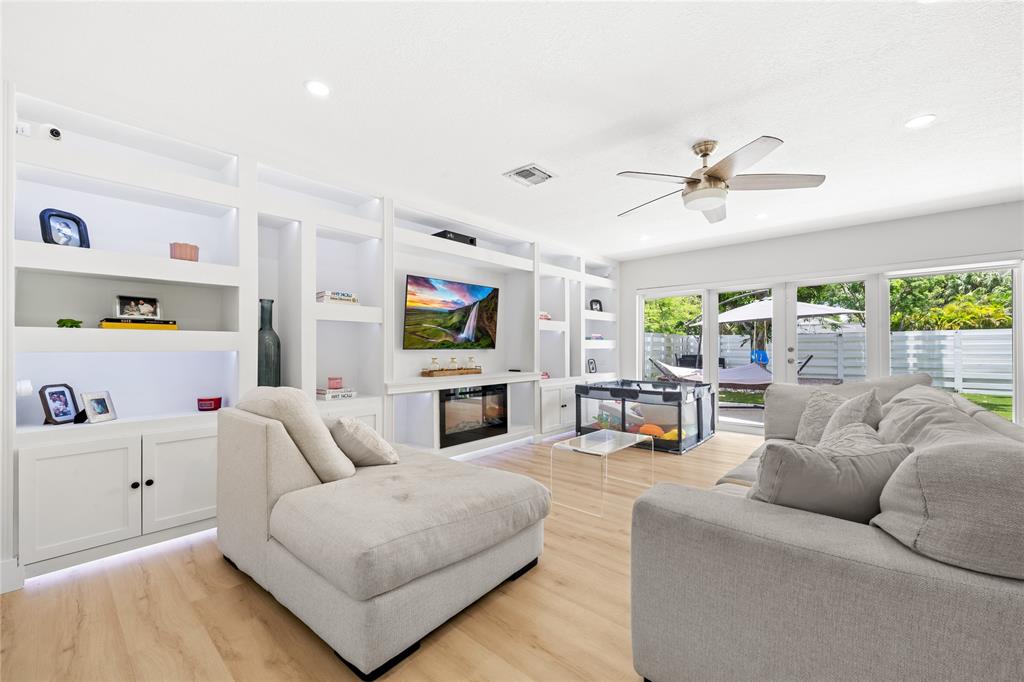 14908 Southwest 143rd Place Miami, FL 33186 - Photo 23 of 45 a living room with furniture and a flat screen tv