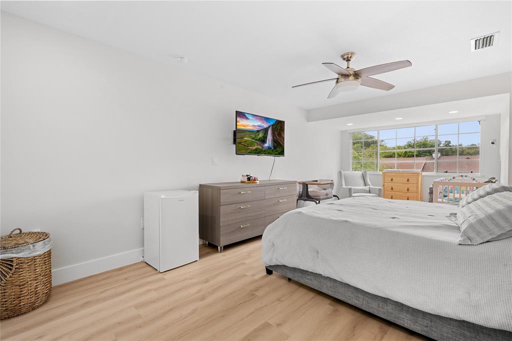 14908 Southwest 143rd Place Miami, FL 33186 - Photo 28 of 45 a bed room with a bed and a television