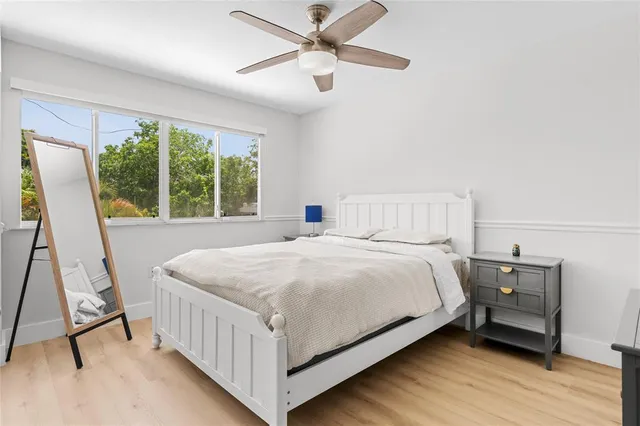 a bedroom with a bed and a large window