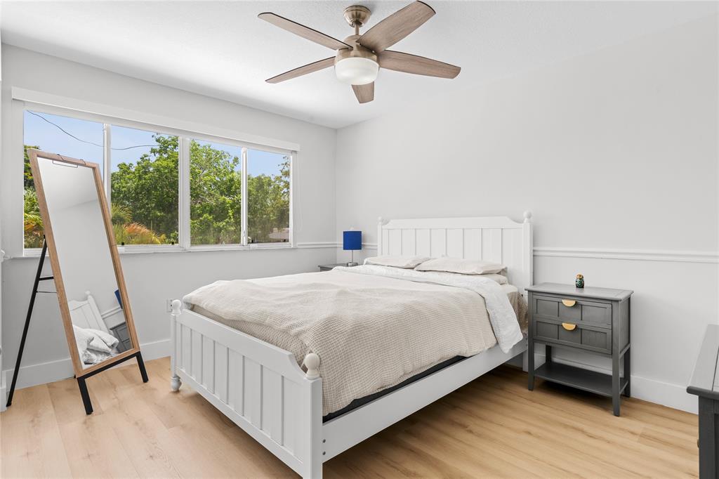 14908 Southwest 143rd Place Miami, FL 33186 - Photo 39 of 45 a bedroom with a bed and a large window