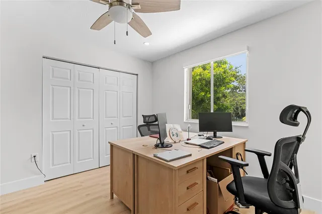 a view of a workspace with furniture and window