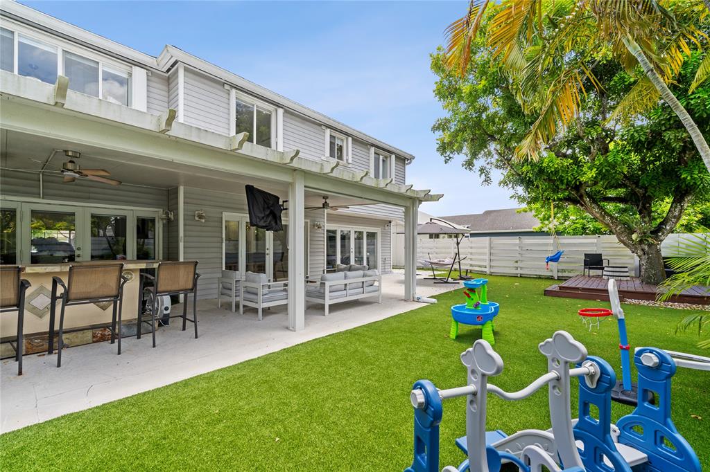 14908 Southwest 143rd Place Miami, FL 33186 - Photo 6 of 45 a front view of house with outdoor seating and yard