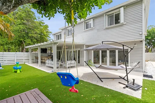 a view of a house with backyard porch and sitting area