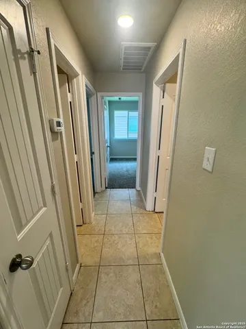 an empty room with windows and mirror