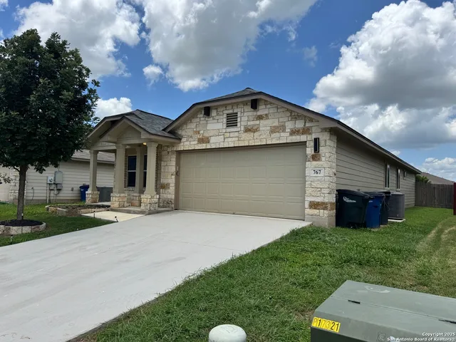a front view of a house with a garden and yard